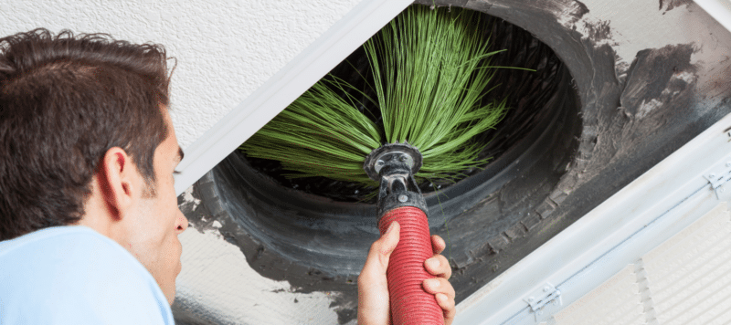 hvac technician performing air duct cleaning